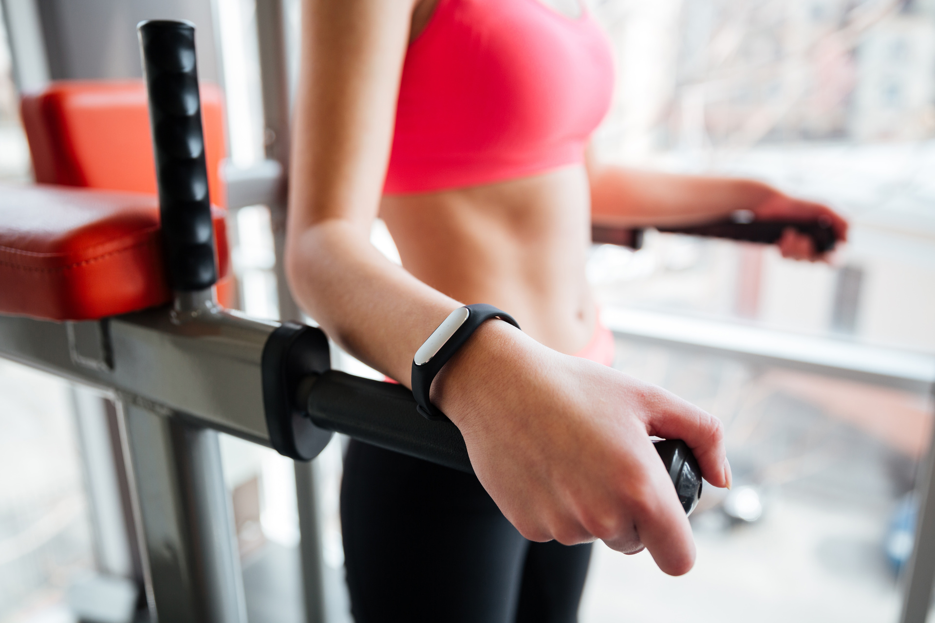 Woman exercising on machine wearing fitness tracker