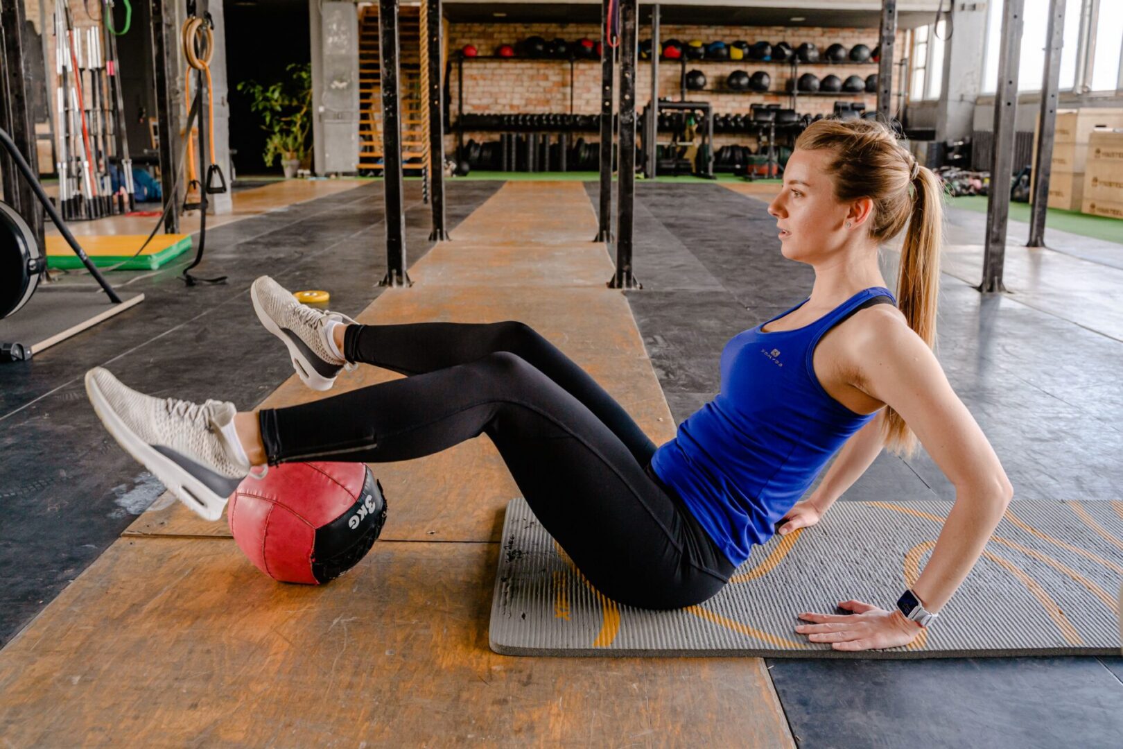 Woman exercising with medicine ball in gym